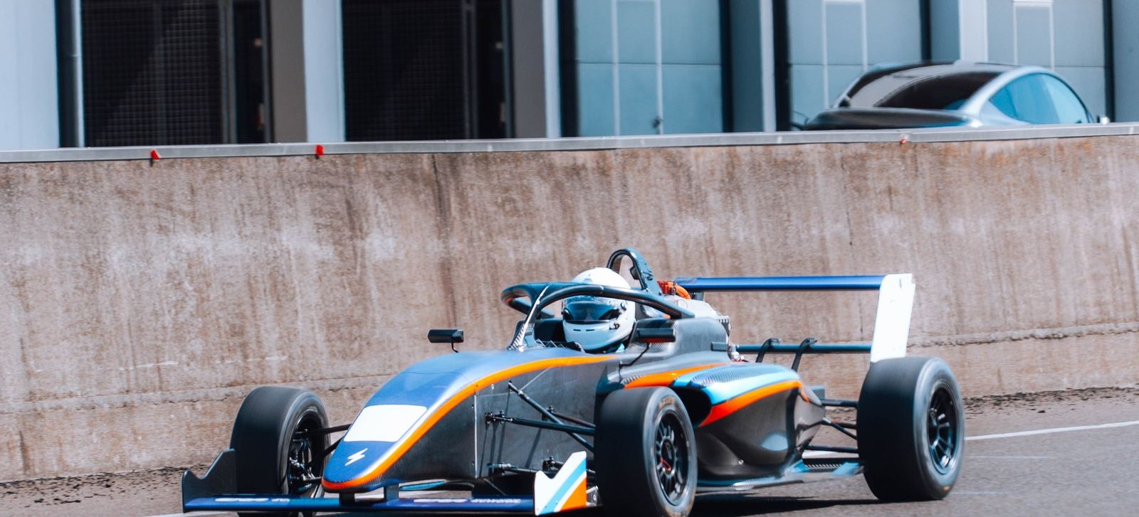 The ARC4 Formula 4 electric car in the pit lane during a track test.